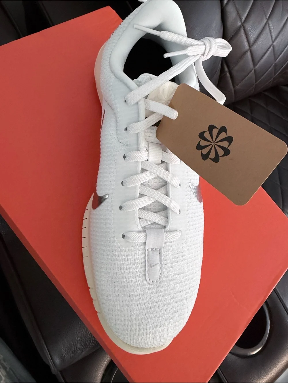 Nike Women's White Sneakers with Silver Swoosh and Black Heel Accent